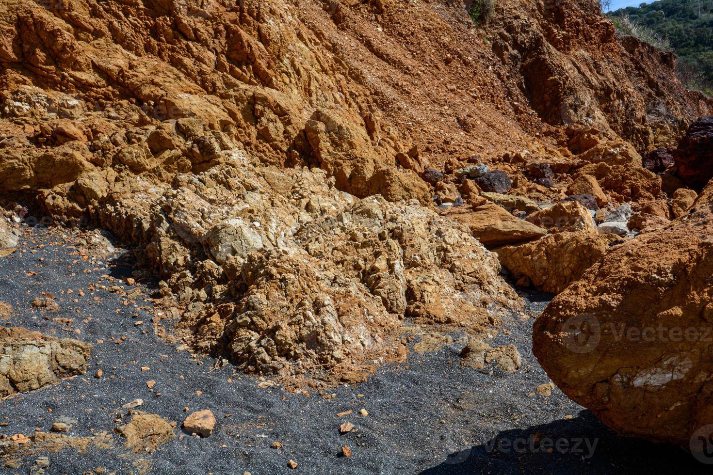 Close-up shot of fallen rocks and sand on the ground. photo