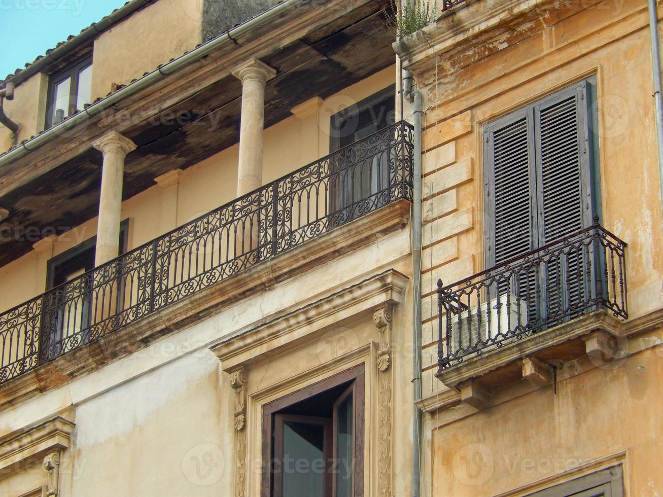 Closeup of a beautiful stone building with a balcony photo