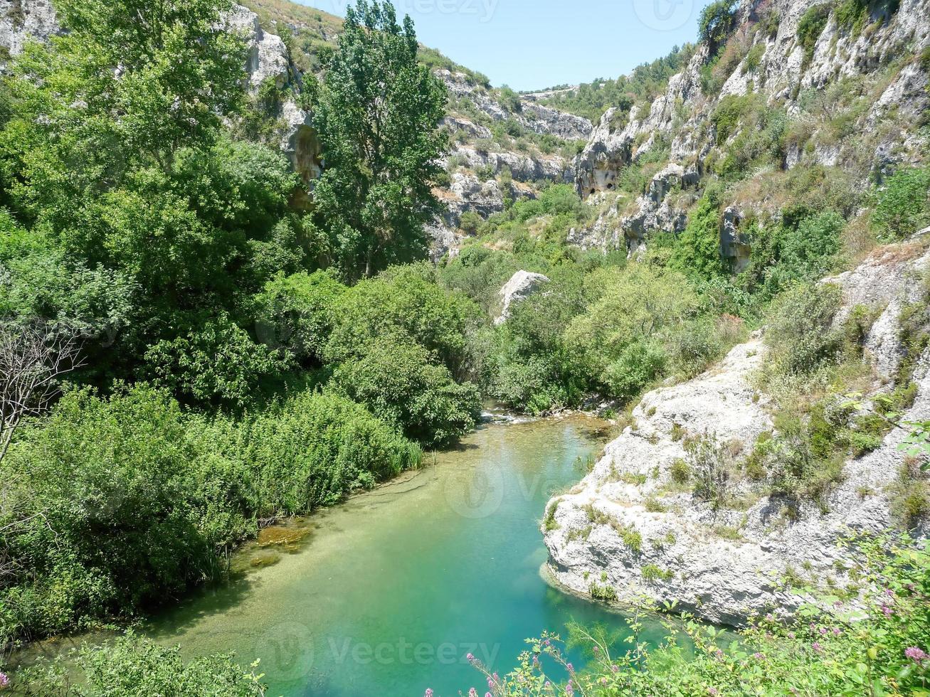 river in the mountains at a sunny day photo