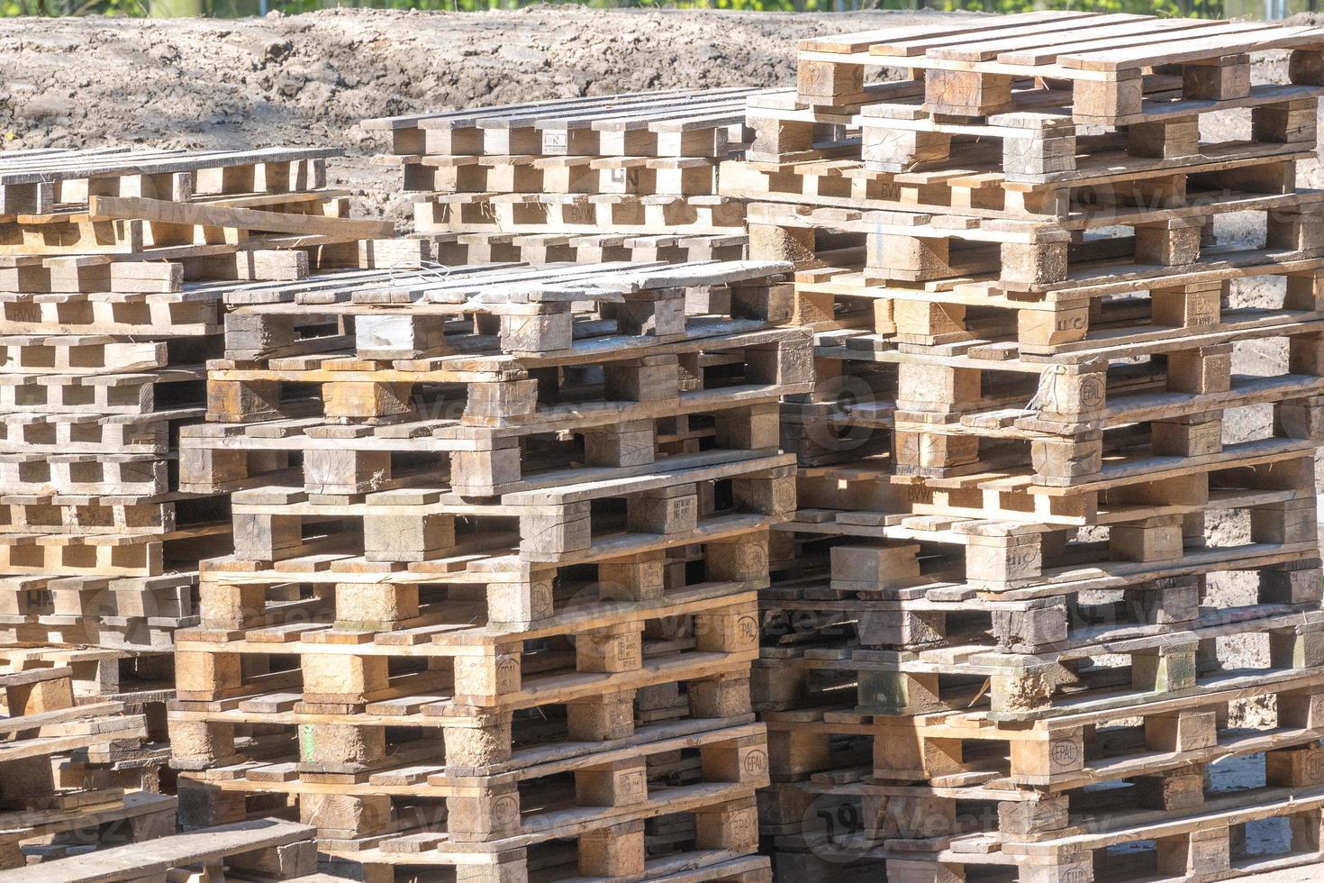 many stacked wooden pallets photo