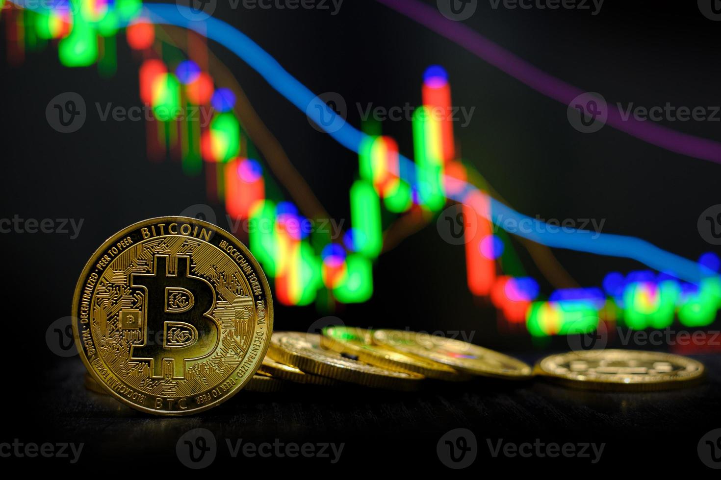 Golden bitcoin cryptocurrency at trading chart background photo