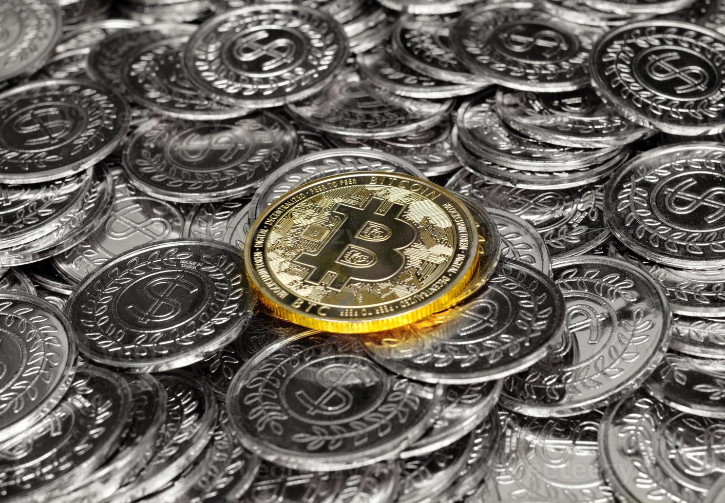 Gold bitcoin cryptocurrency on pile silver coins a lot of photo