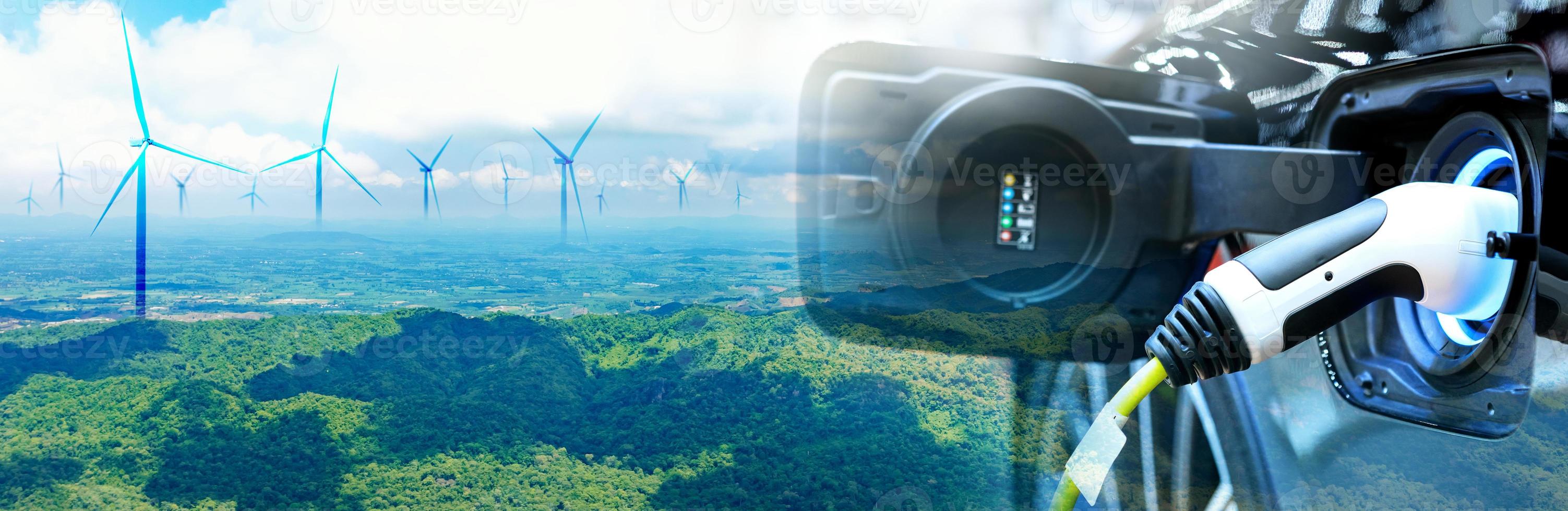 Charge EV car vehicle electric battery on station with wind turbine blue sky on panoramic background. Idea nature electric energy technology green eco car environment friendly concept. Double exposure photo
