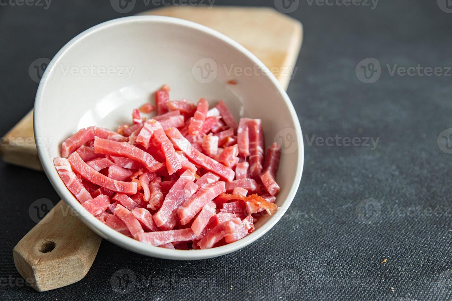 bacon small raw pieces pork meat fumees cuire fresh healthy meal food snack diet on the table copy space food photo