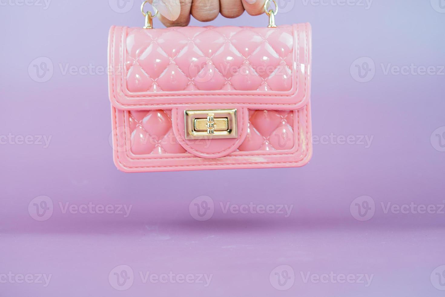 Stylish pink ladies handbag isolated on background. photo