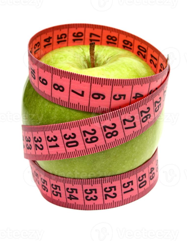 green apple and measuring ribbon for diet photo