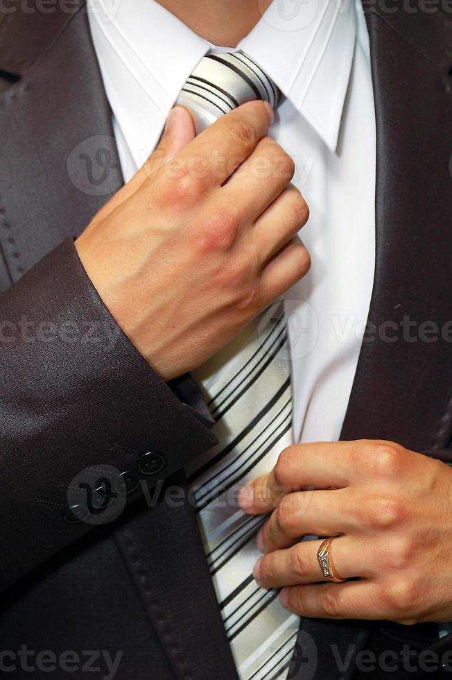 man hands remedying tie photo