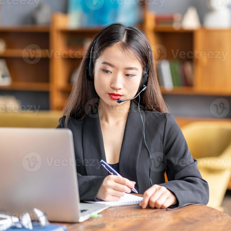 Asian woman studying online course, distance education on laptop photo