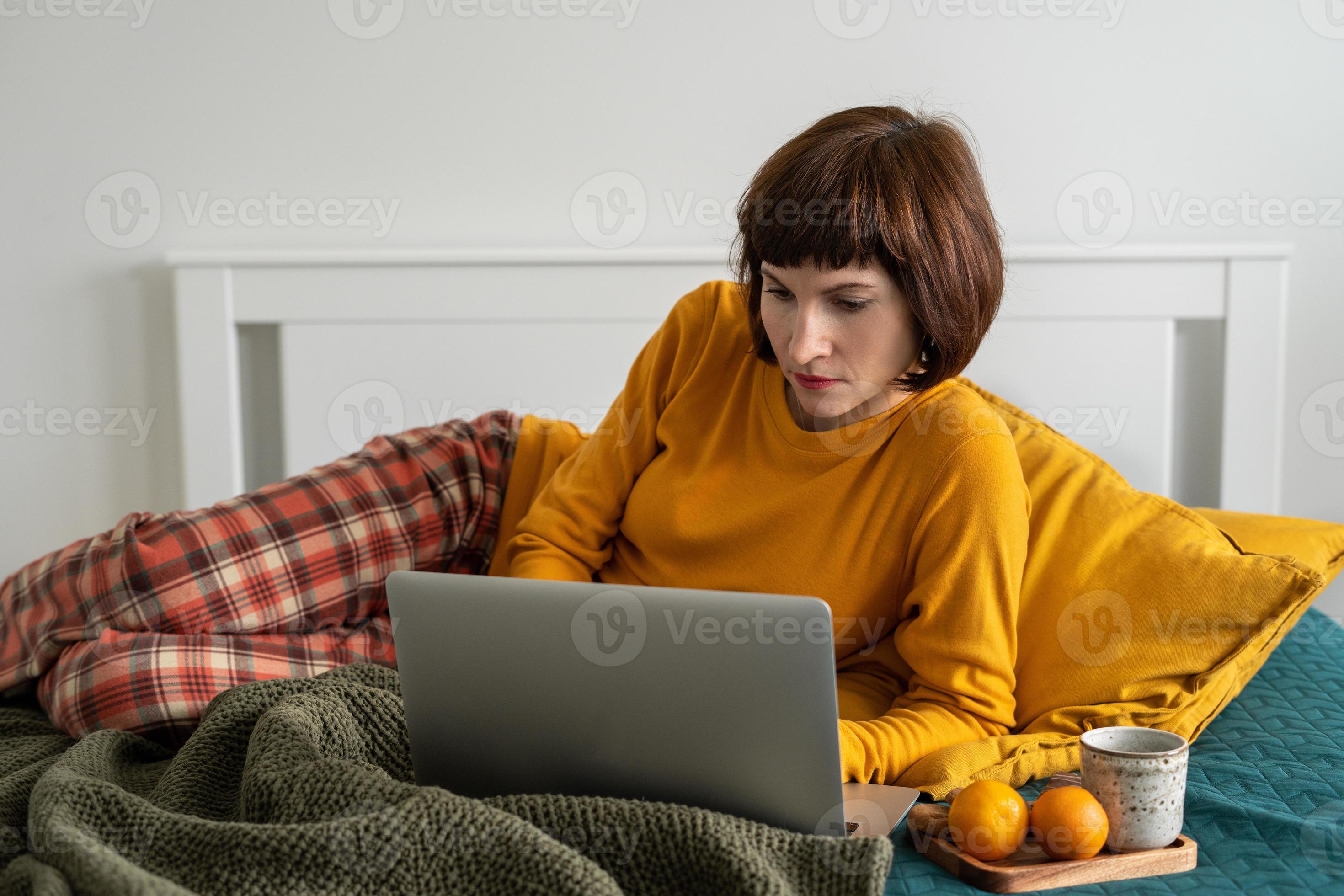 Mature woman laying on bed in bedroom