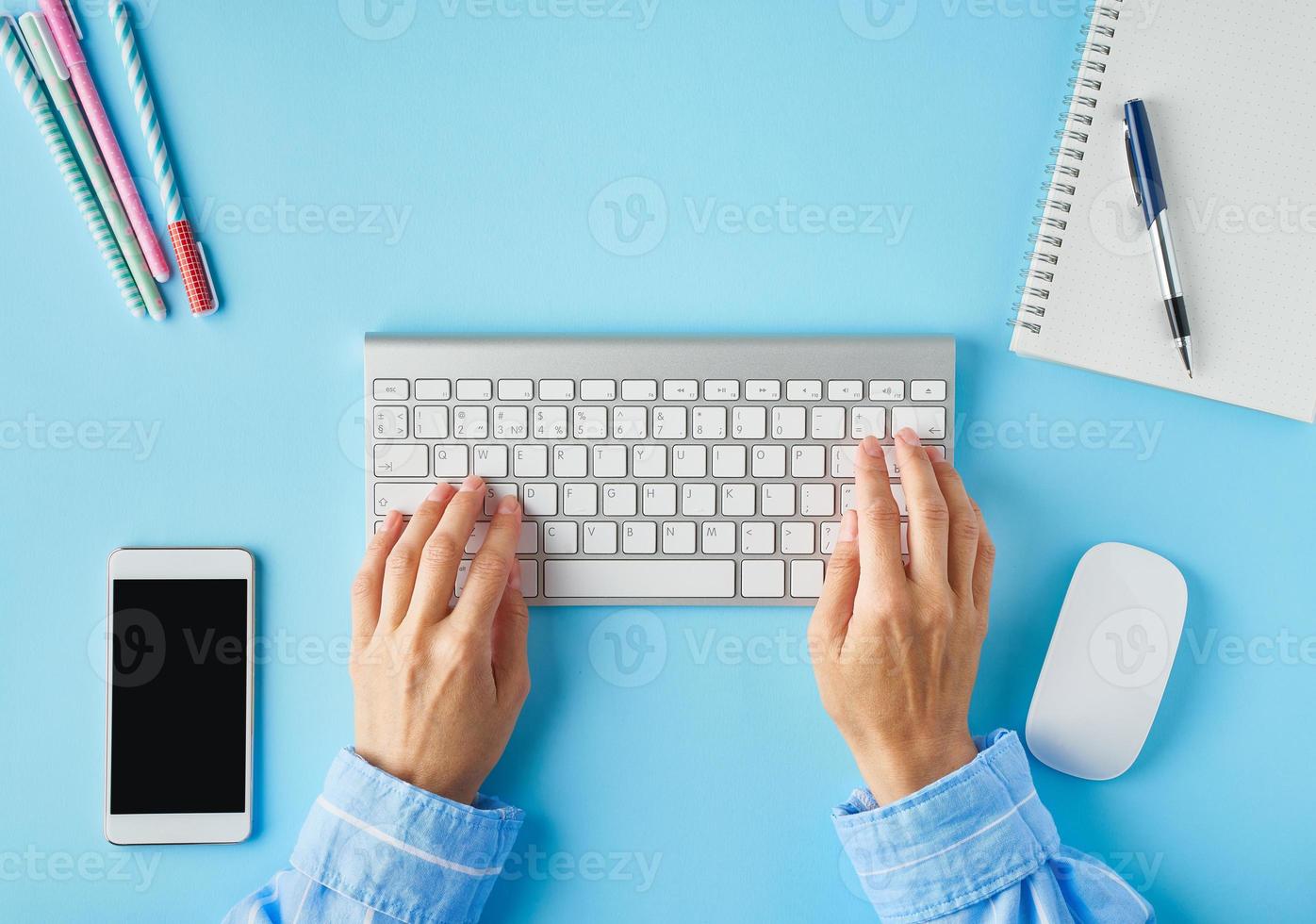 Bright blue modern desk. Top view. Distance education. Copy space, mock up. photo