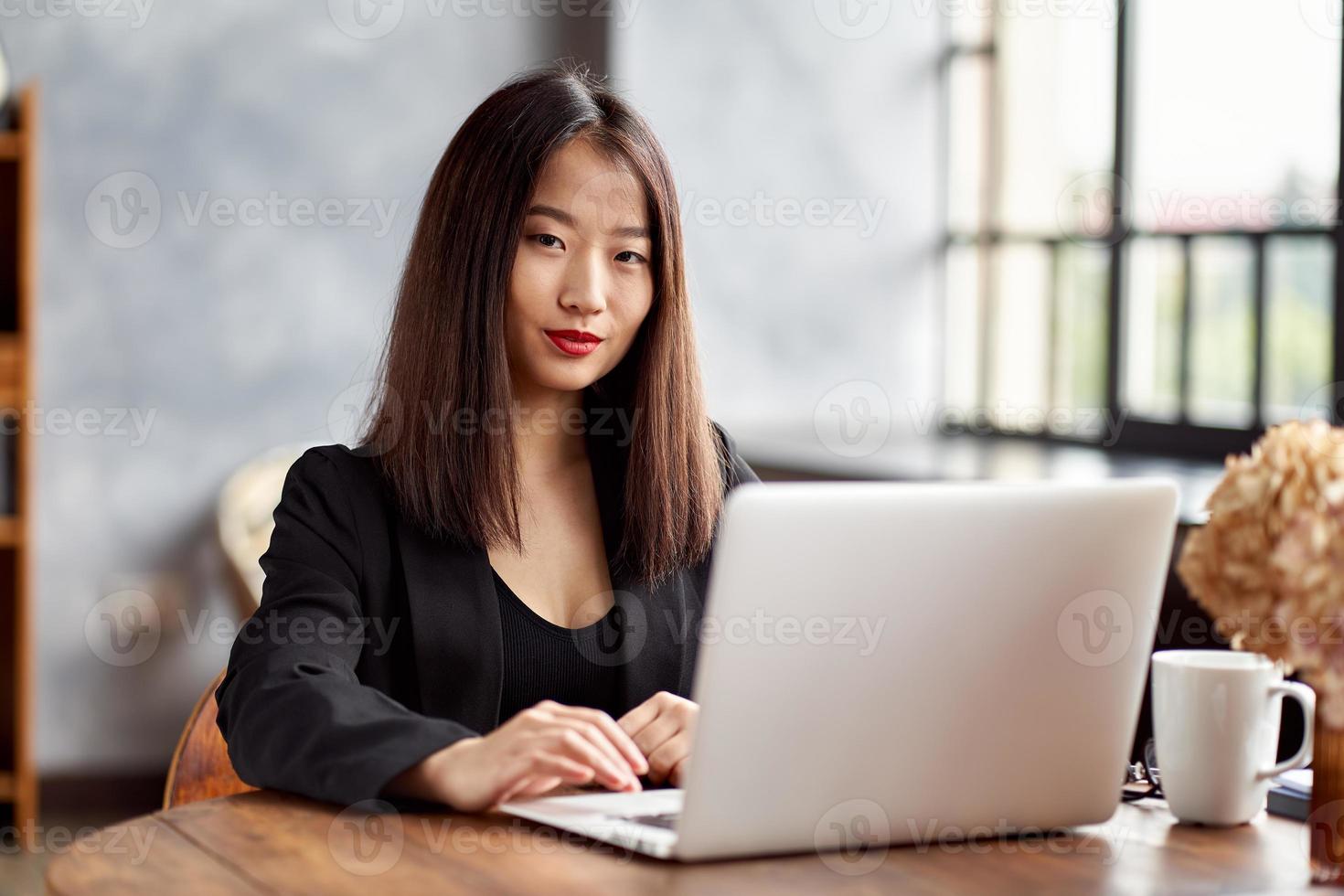 Asian business woman working in laptop in office. Japanese businesswoman photo