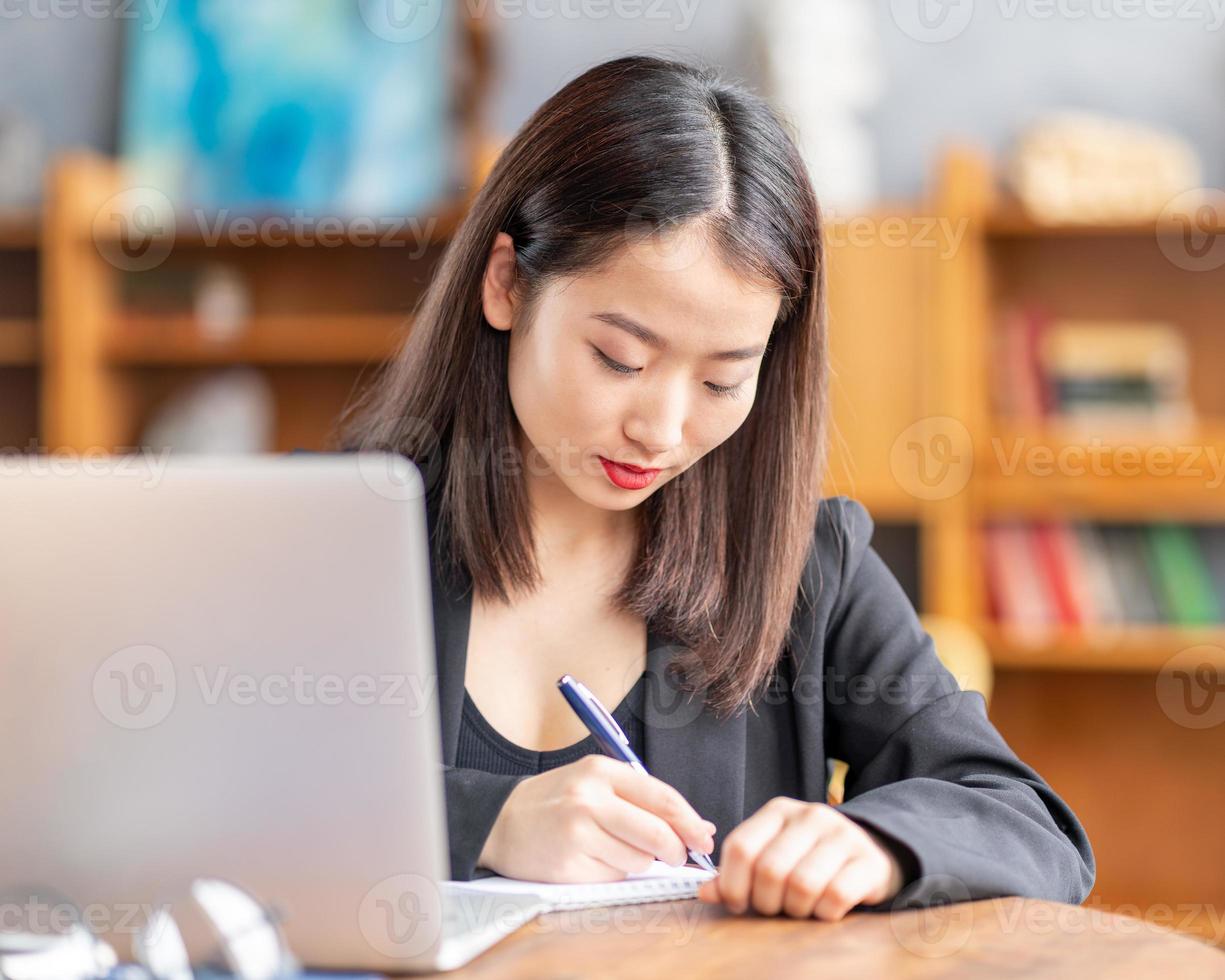 Asian woman studying online course, distance education on laptop. Japanese businesswoman photo