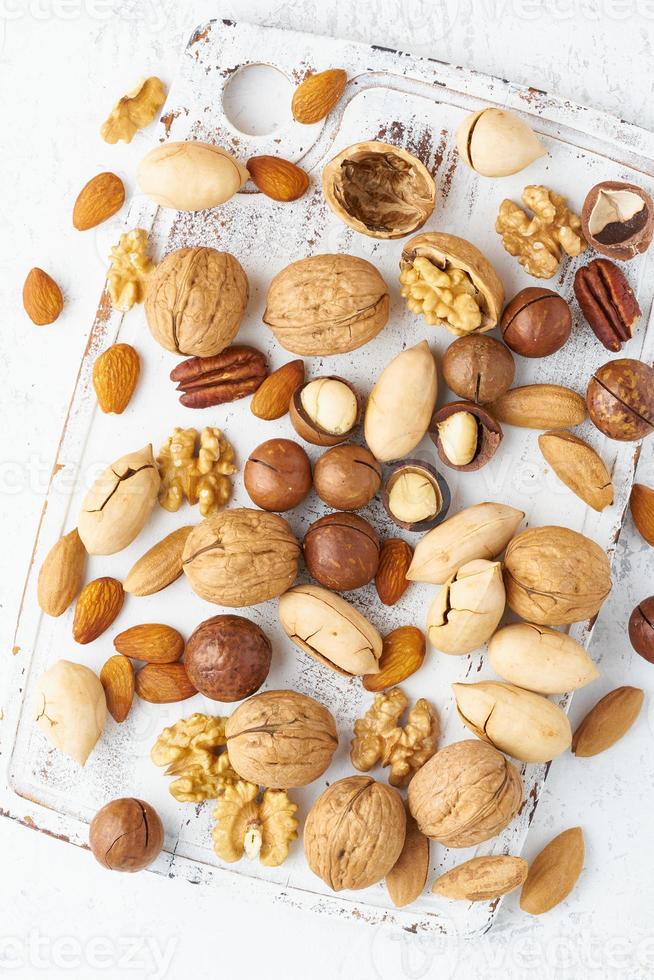 Mix of nuts - walnut, almonds, pecans, macadamia and knife for opening shell photo