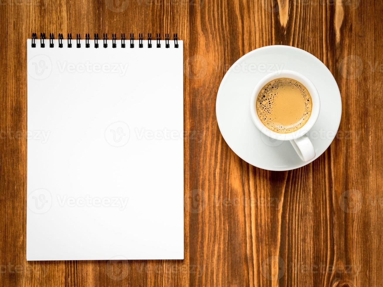 coffee in white cup and open notepad photo