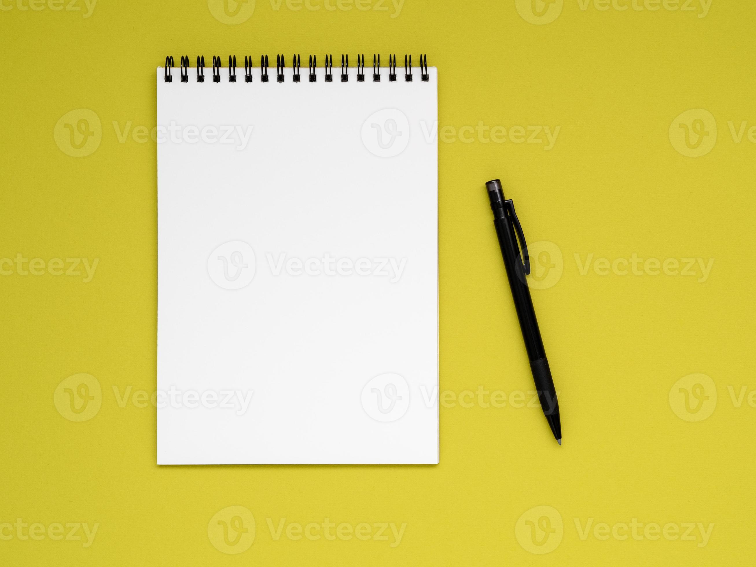 open notepad on the spiral with a clean white page and pencil on a bright  yellow background color 7280908 Stock Photo at Vecteezy
