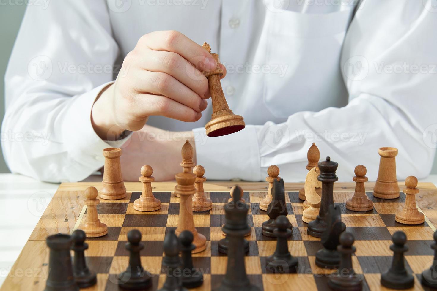 Man play chess during quarantine due to coronavirus pandemic. Boy play Board games. photo