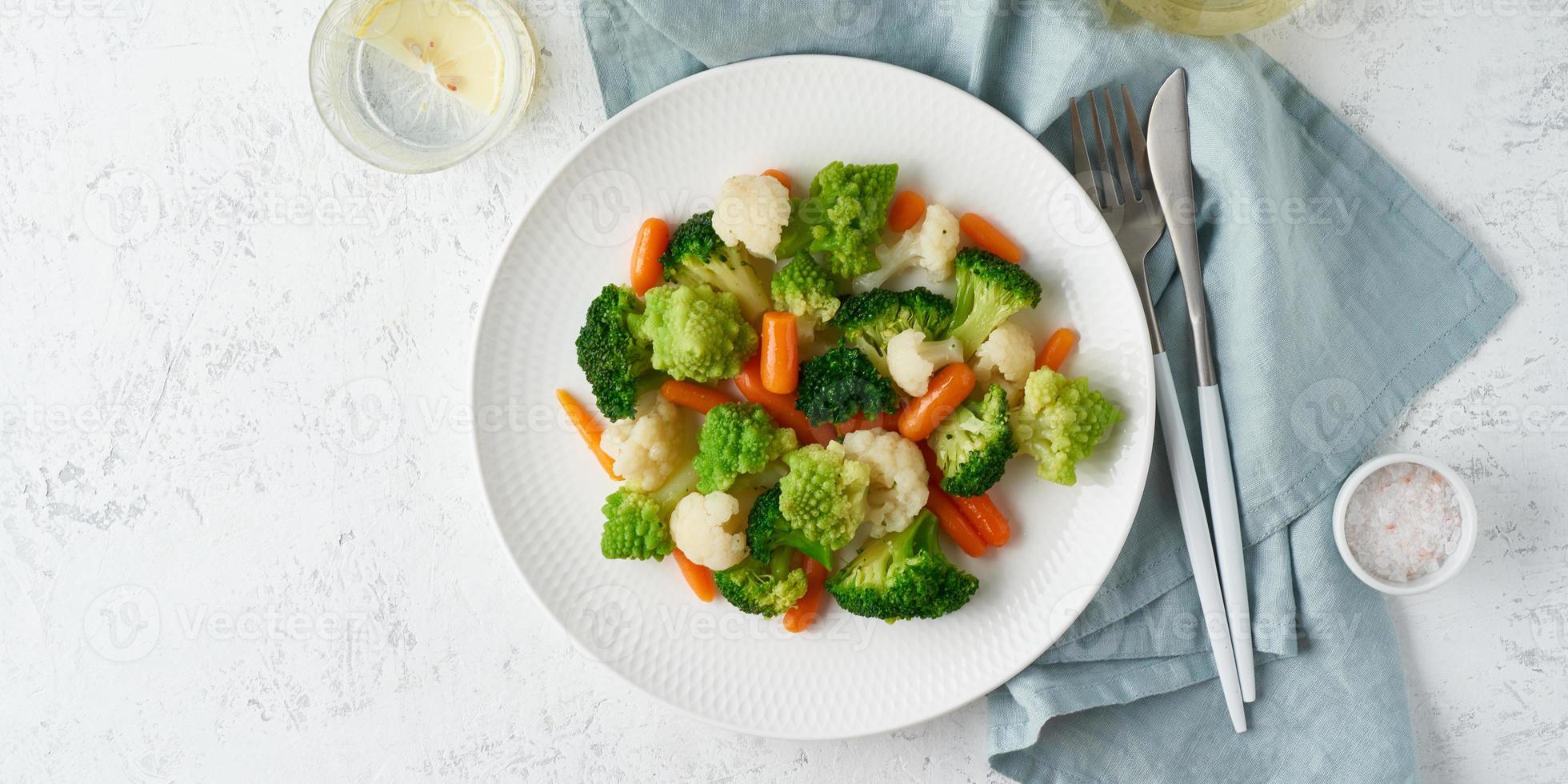 Mix of boiled vegetables. Broccoli, carrots, cauliflower. Steamed vegetables for low-calorie diet photo