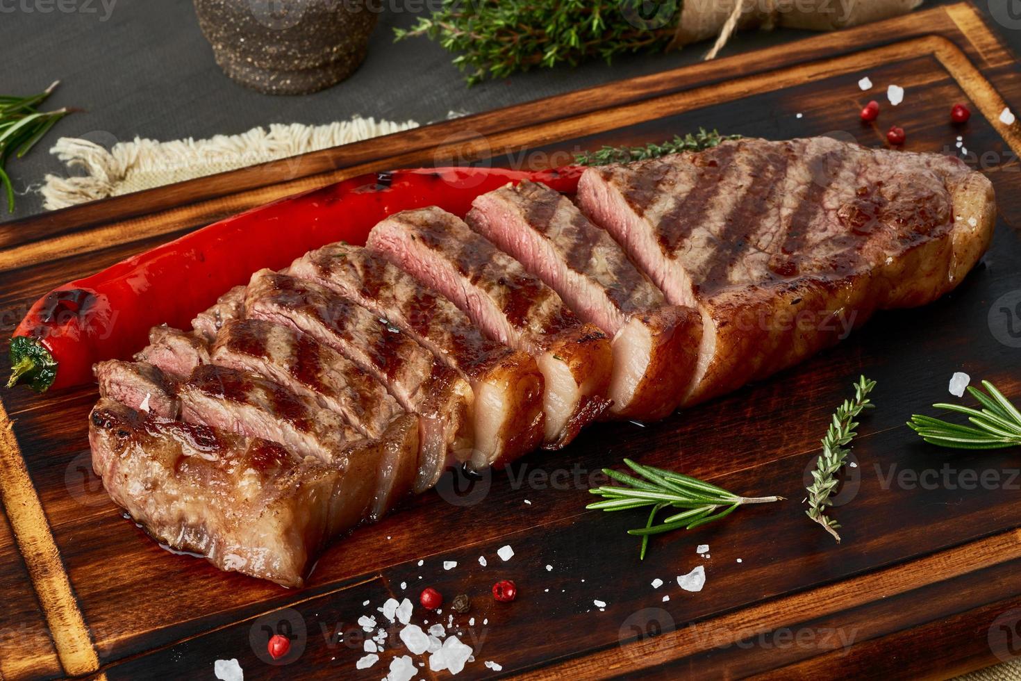 Keto ketogenic diet medium beef steak, grilled striploin on cutting board. Paleo food photo