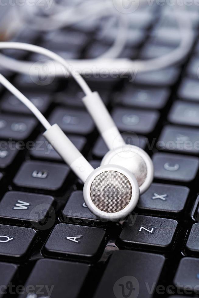 Earphones over keyboard photo