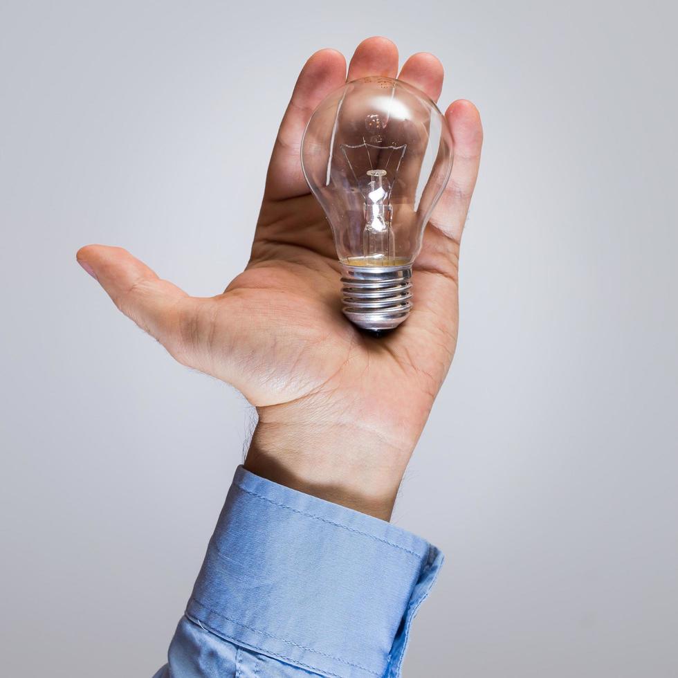 Hand with light bulb photo