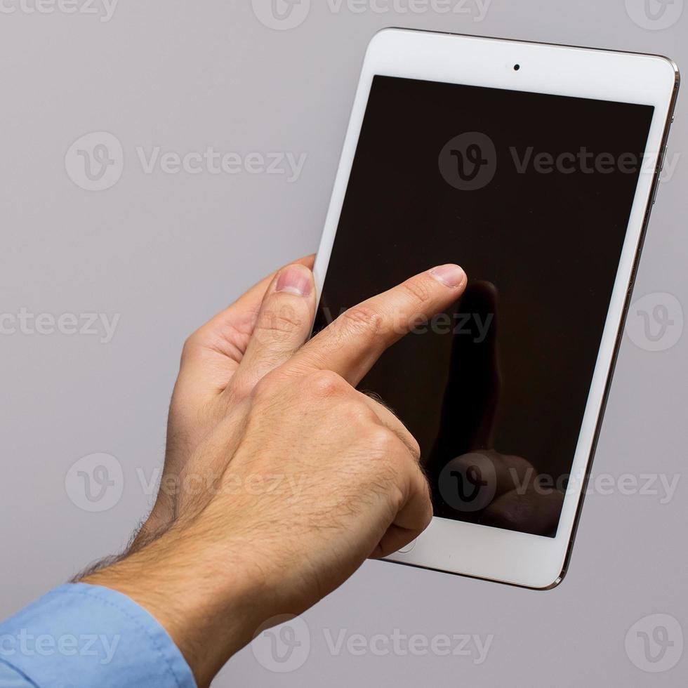 White tablet pc in hands photo