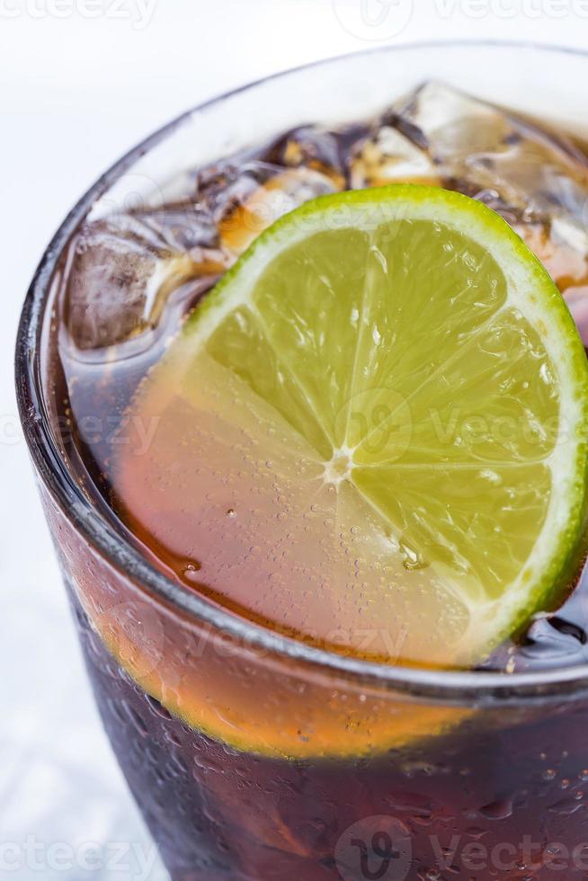 Fresh cocktail with cola drink and lime photo