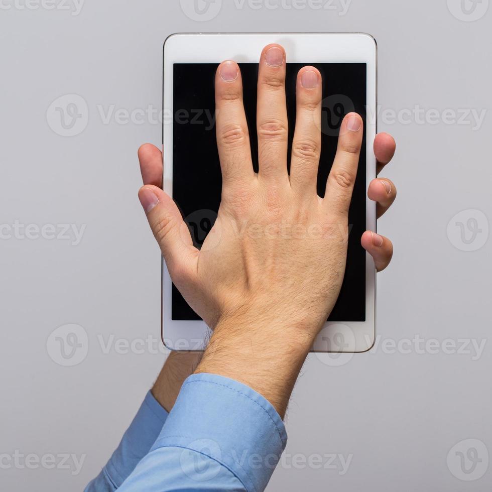 White tablet pc in hands photo