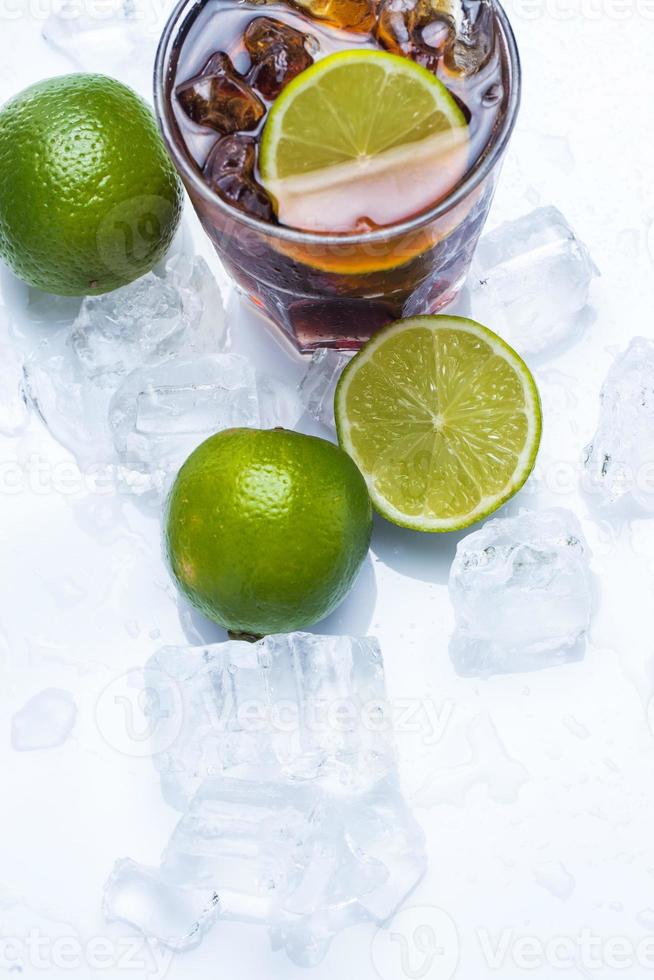 Fresh cocktail with cola drink and lime photo