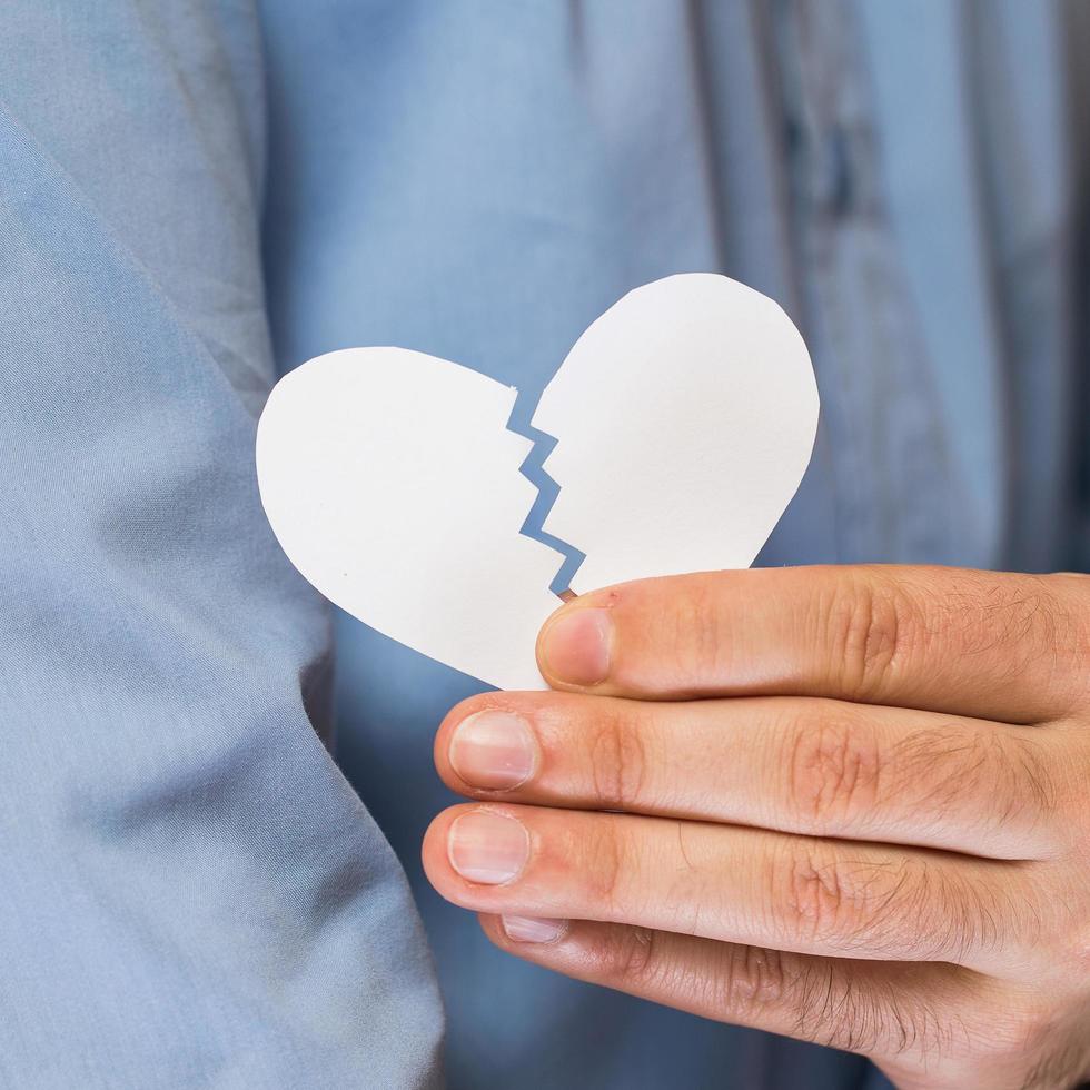 Hand with broken paper heart photo