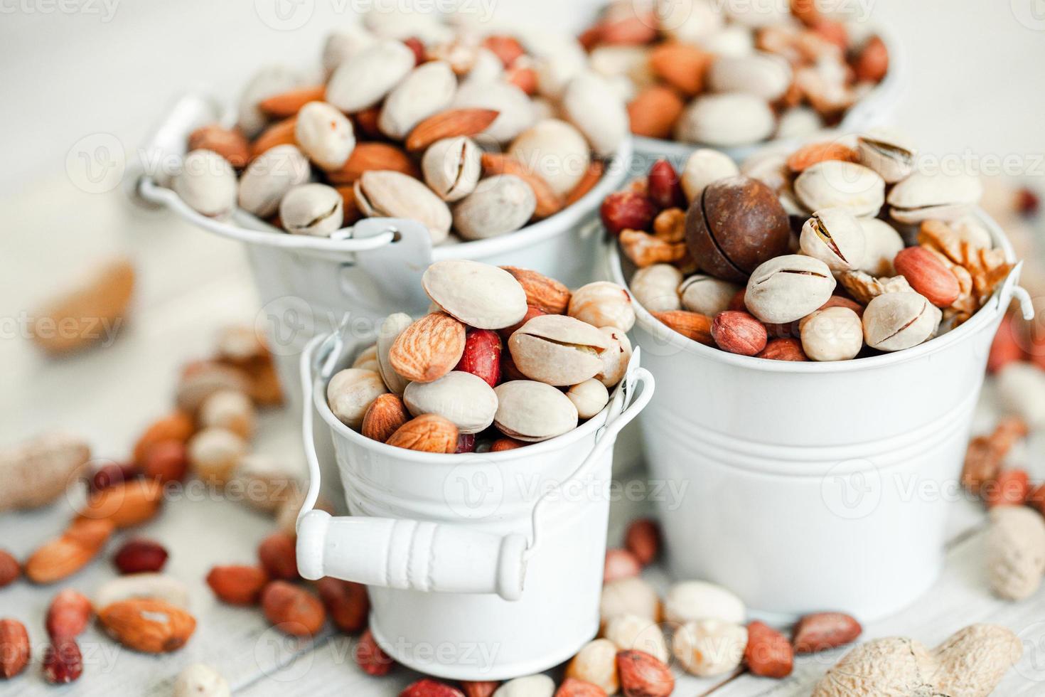 Assorted nuts for a background Almond, walnut,cashew, pistachios, hazelnuts, peanuts, Macadamia Collection of different varieties of nuts. Composition with dried fruits Healthy food. Organic. photo