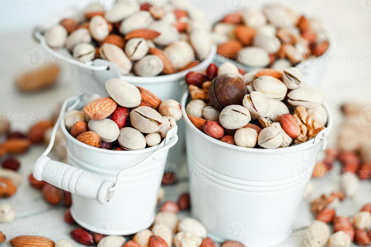Assorted nuts for a background Almond, walnut,cashew, pistachios, hazelnuts, peanuts, Macadamia Collection of different varieties of nuts. Composition with dried fruits Healthy food. Organic. photo