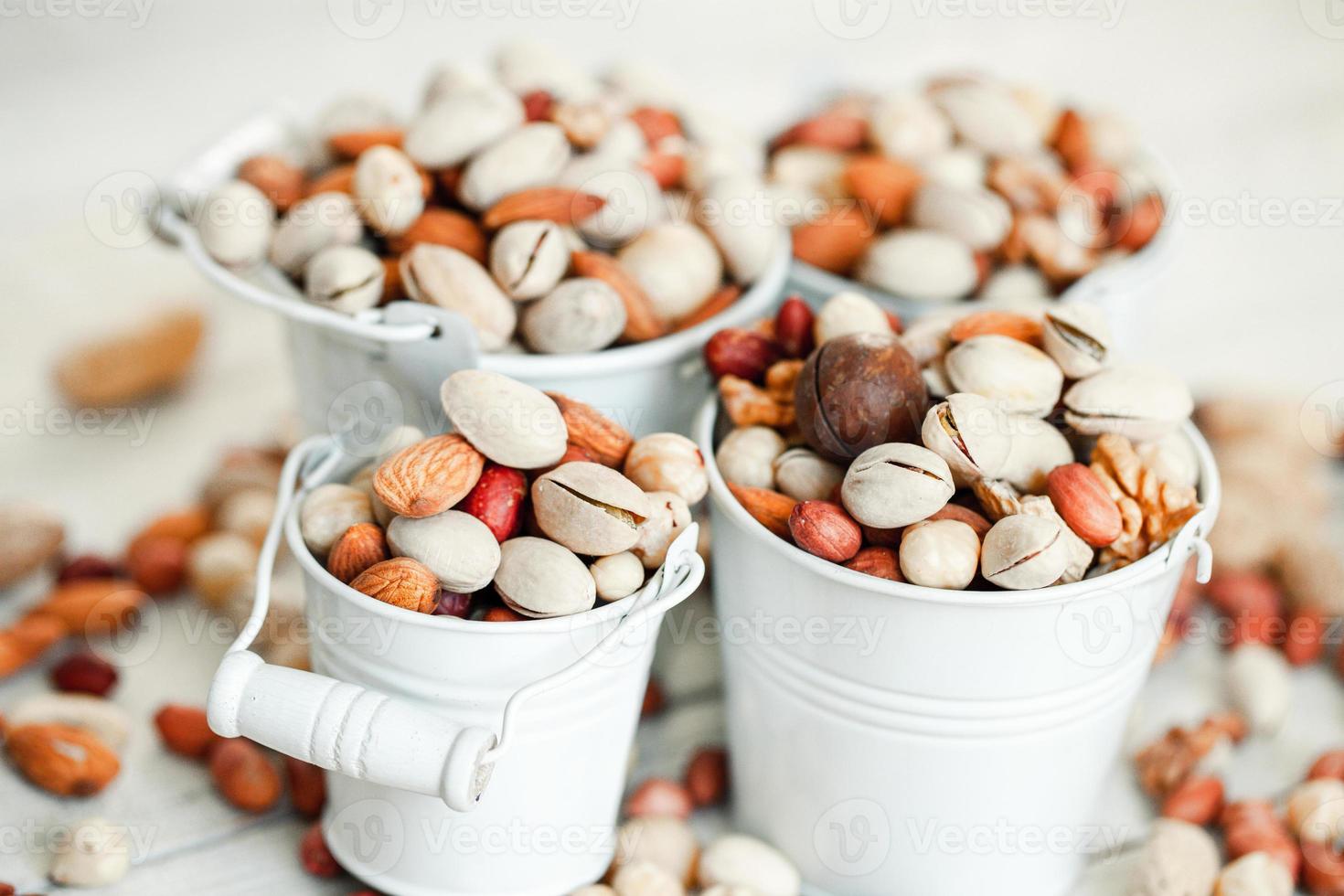 Assorted nuts for a background Almond, walnut,cashew, pistachios, hazelnuts, peanuts, Macadamia Collection of different varieties of nuts. Composition with dried fruits Healthy food. Organic. photo