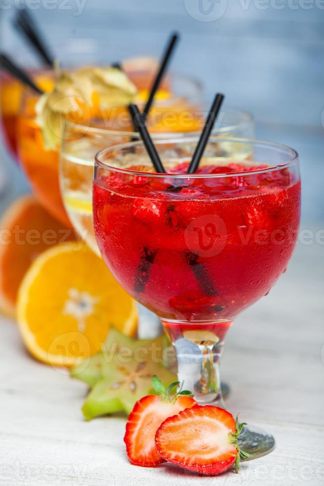 Various alcoholic cocktails on white background. Colorful cocktails close up. Fruit juice cocktail drink. assorted cocktail drinks. Glasses of fruit drinks with ice cubes on table in cafe photo