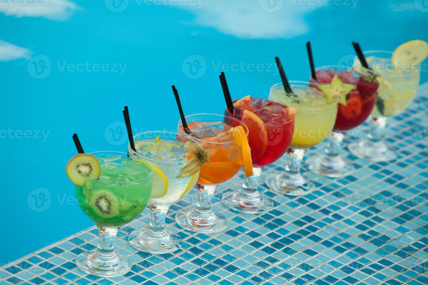 Various alcoholic cocktails on white background. Colorful cocktails close up. Fruit juice cocktail drink. assorted cocktail drinks. Glasses of fruit drinks with ice cubes on table in cafe photo