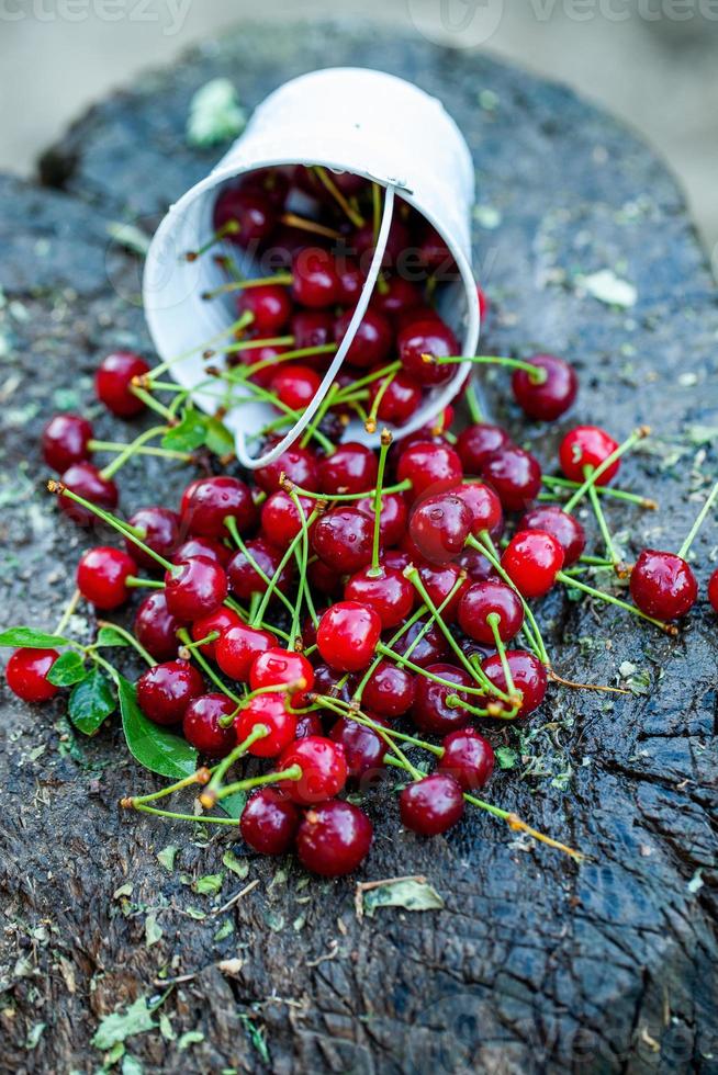 Fresh cherries in bowl. Close up view of pile of red ripe cherries. Red fruits in garden. photo