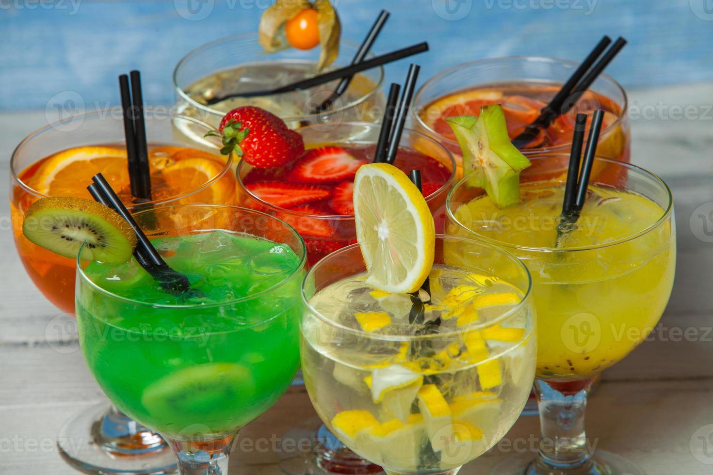 Various alcoholic cocktails on white background. Colorful cocktails close up. Fruit juice cocktail drink. assorted cocktail drinks. Glasses of fruit drinks with ice cubes on table in cafe photo