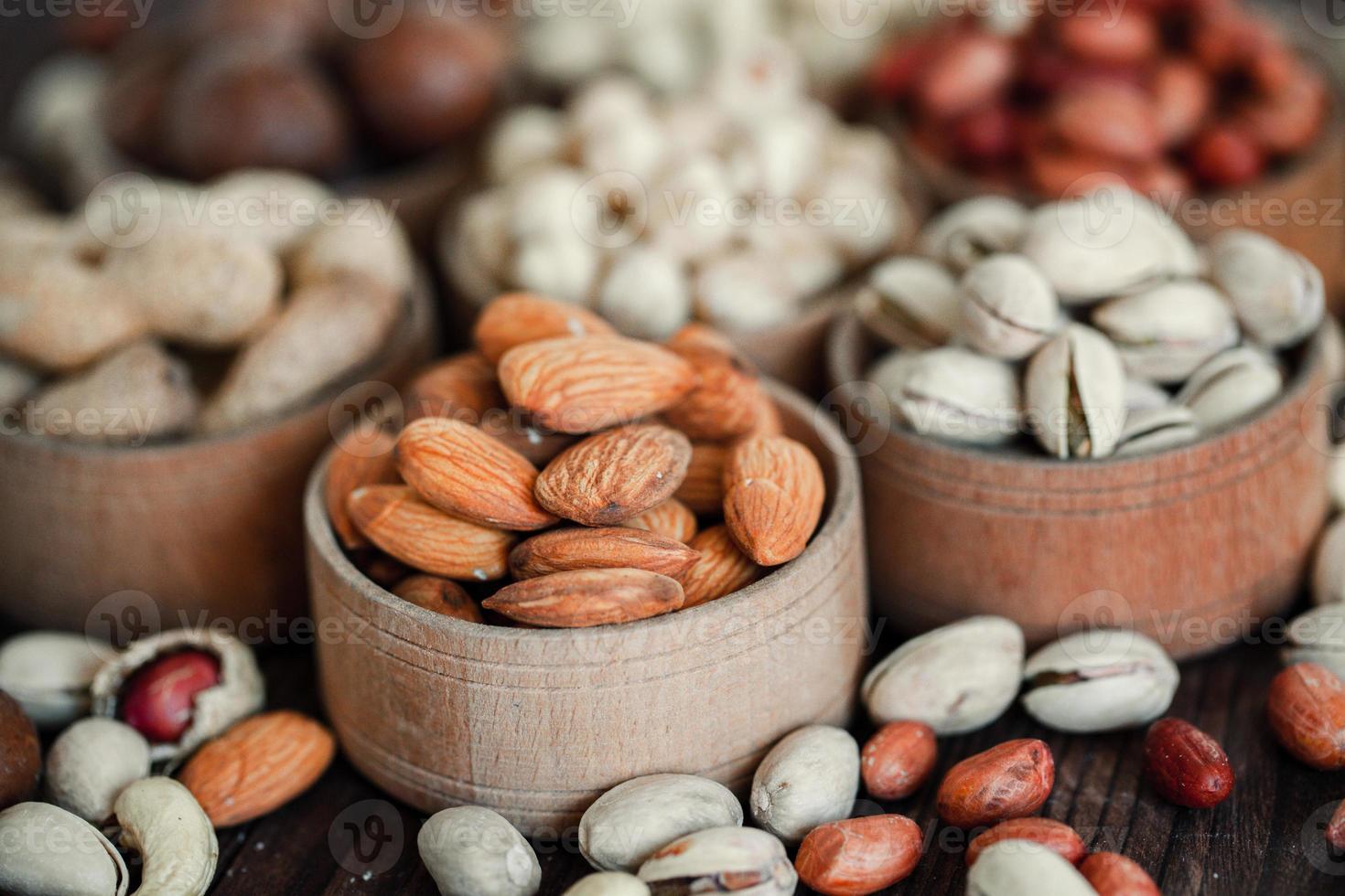 Assorted nuts for a background Almond, walnut,cashew, pistachios, hazelnuts, peanuts, Macadamia Collection of different varieties of nuts. Composition with dried fruits Healthy food. Organic. photo