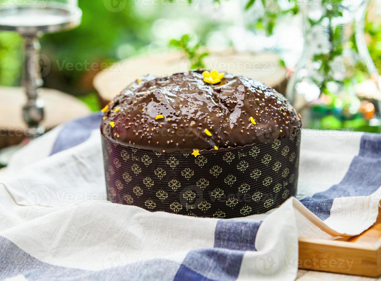 Home Made Panettone. Traditional Italian sweet bread. Panettone with a slice served on a wooden table. photo