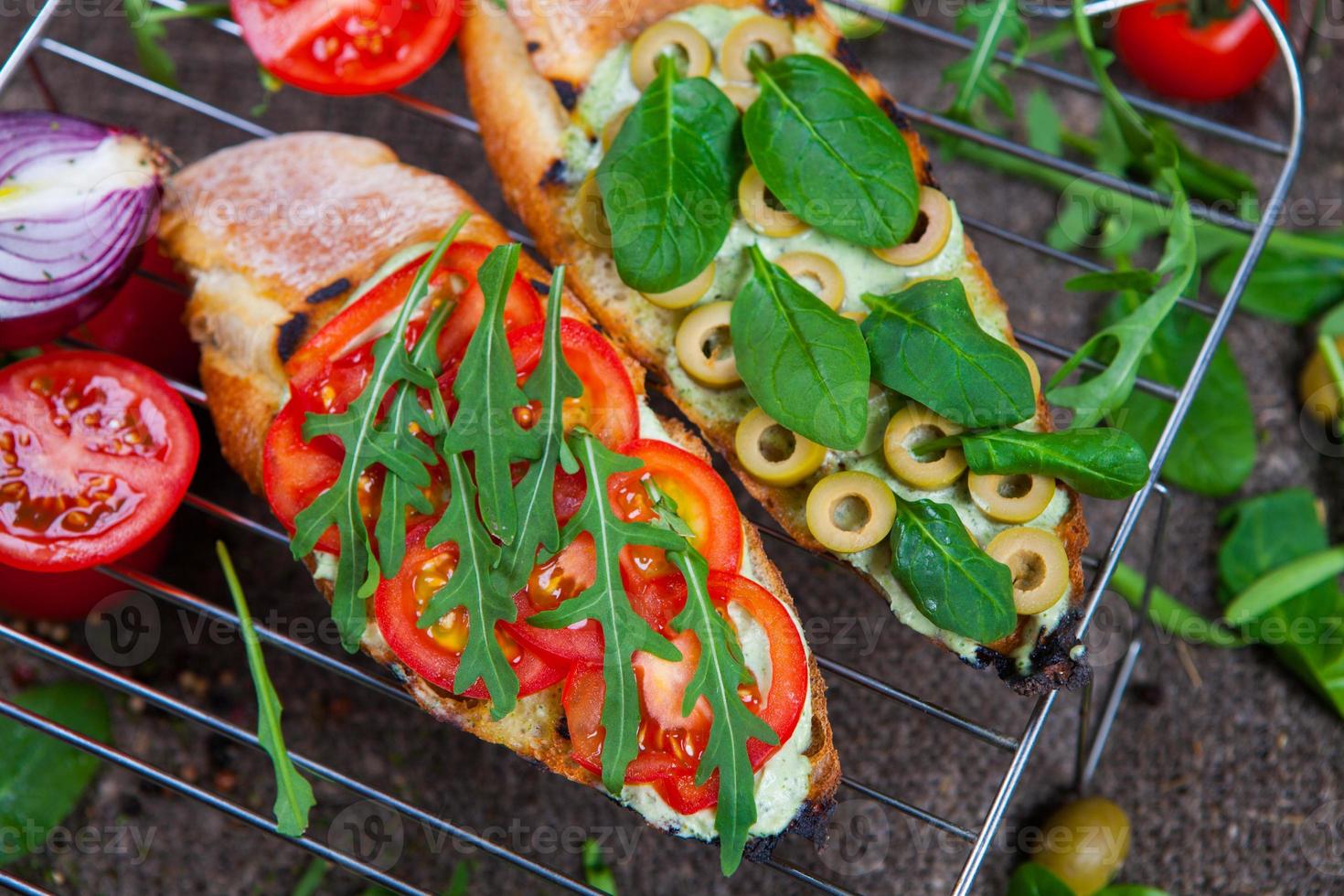 Appetizing bruschetta. Traditional Italian bruschetta. Open sandwich with salmon and vegetables. Delicious healthy food. European cuisine. photo