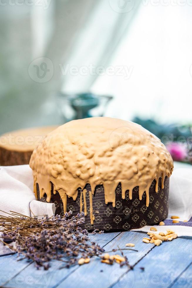 Home Made Panettone. Traditional Italian sweet bread. Panettone with a slice served on a wooden table. photo