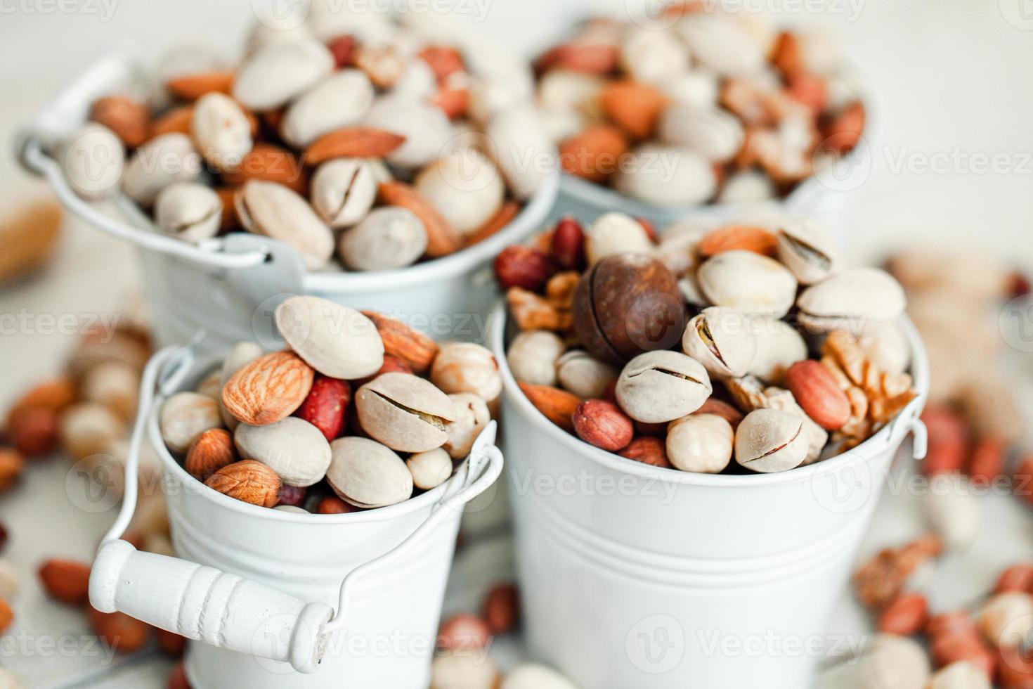 Assorted nuts for a background Almond, walnut,cashew, pistachios, hazelnuts, peanuts, Macadamia Collection of different varieties of nuts. Composition with dried fruits Healthy food. Organic. photo