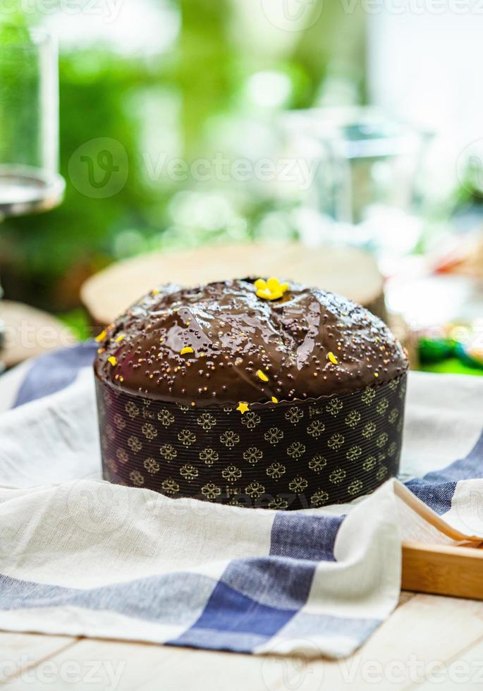 Home Made Panettone. Traditional Italian sweet bread. Panettone with a slice served on a wooden table. photo