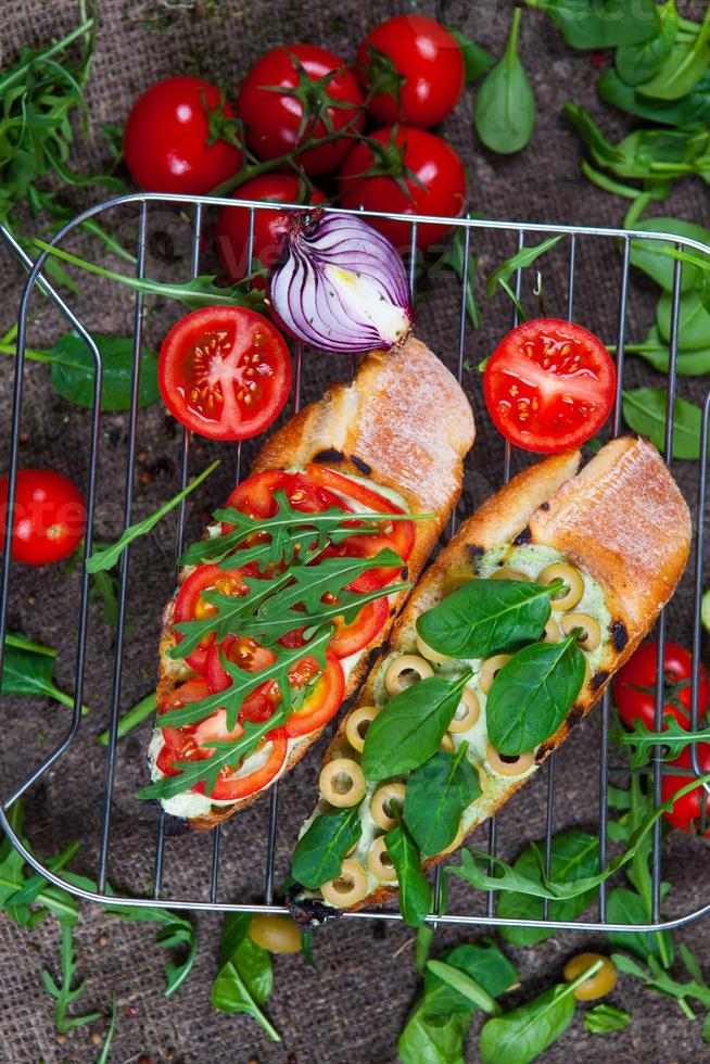 Appetizing bruschetta. Traditional Italian bruschetta. Open sandwich with salmon and vegetables. Delicious healthy food. European cuisine. photo