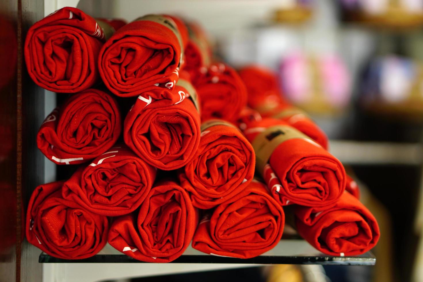 shirts were rolled up in circles and sold in shelves. photo