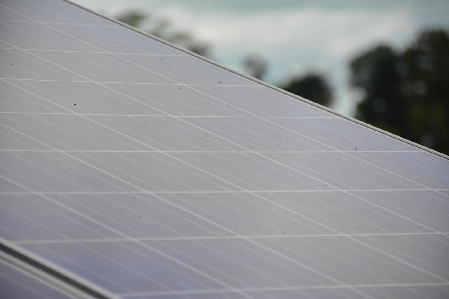 selective focus.Solar panels on the roof of a tropical city house early in the morning photo