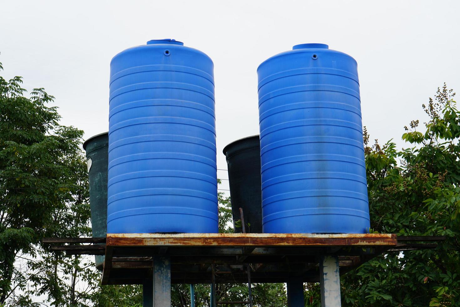 The blue water tank is high up to let the water down lower. photo
