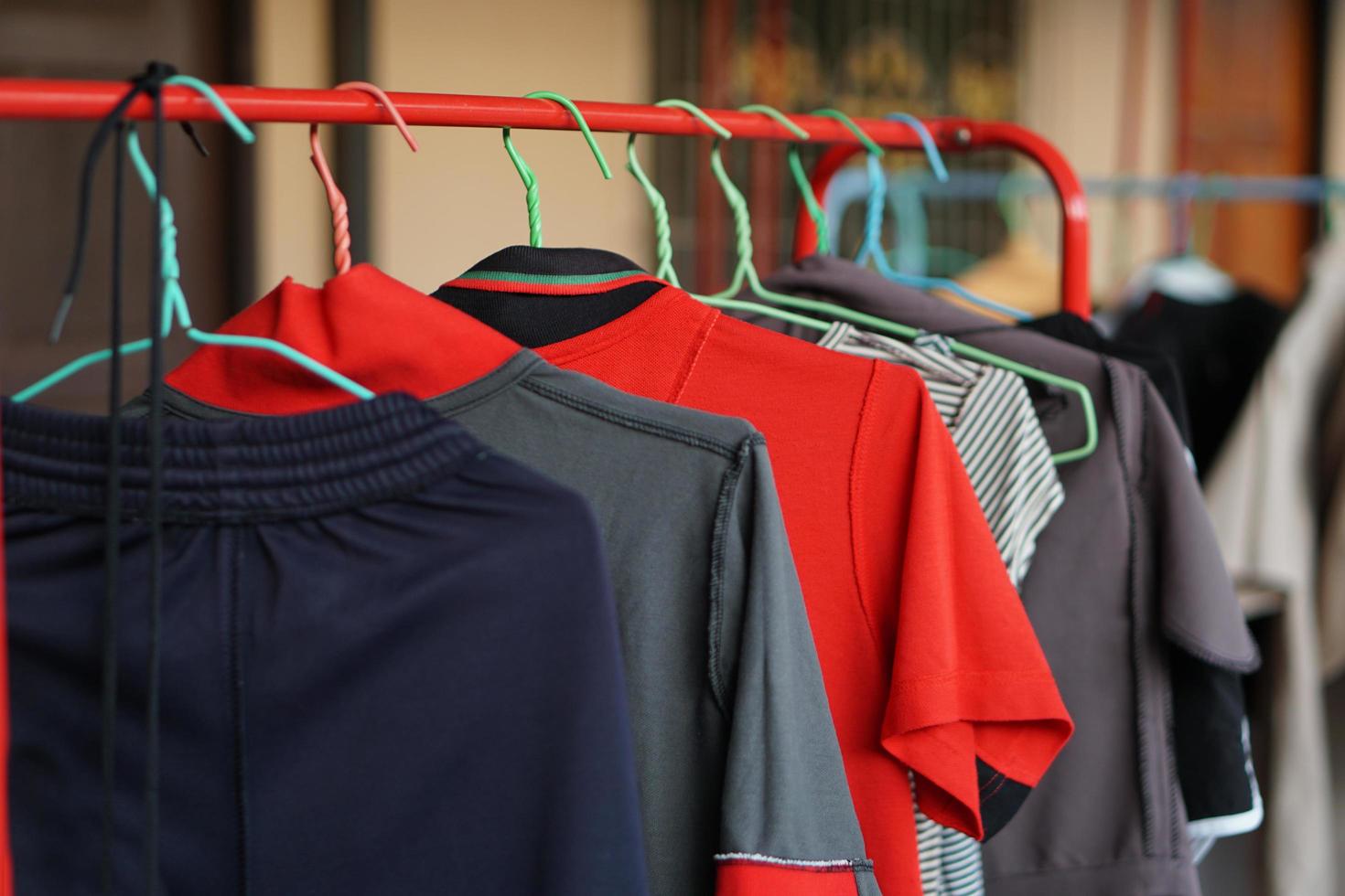 Multi-colored t-shirts on a hanger. Clothing store. photo