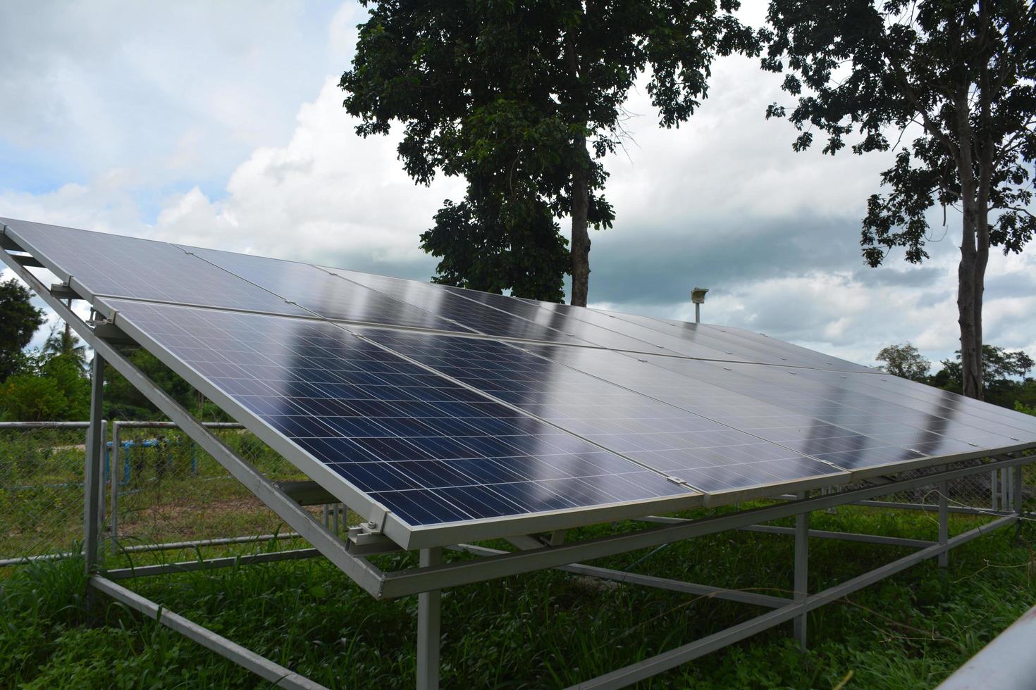 selective focus.Solar panels on the roof of a tropical city house early in the morning photo