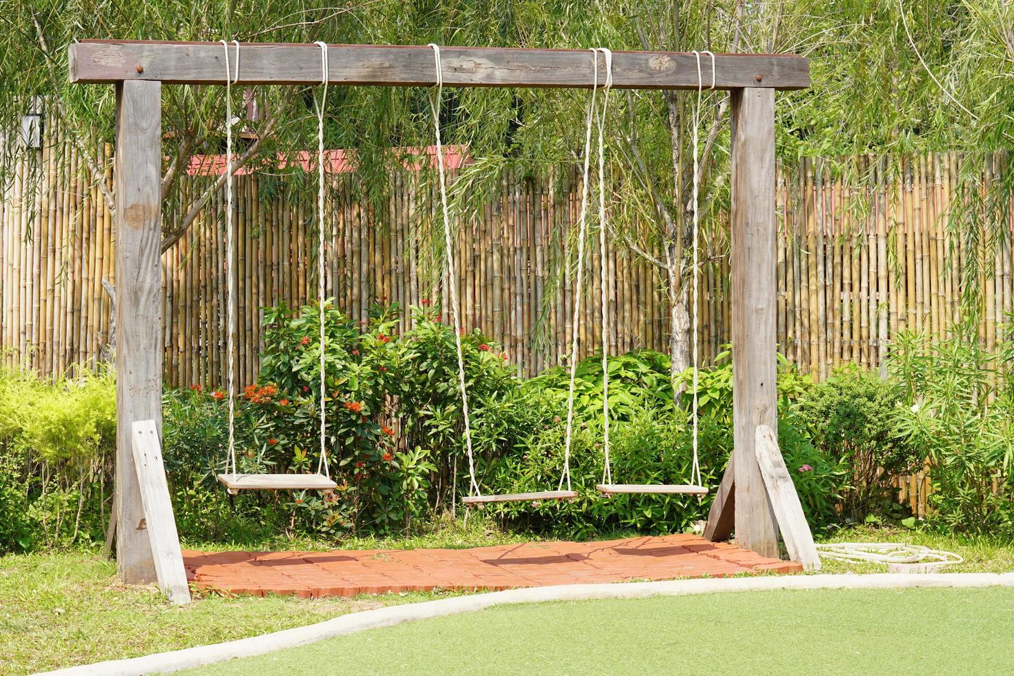 Wooden swings in the playground photo