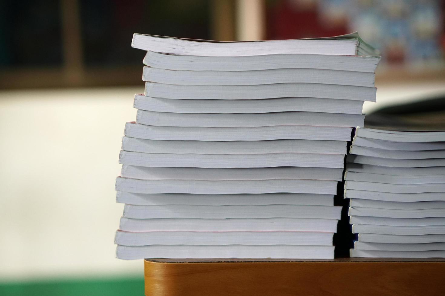 Book stack on wood desk photo